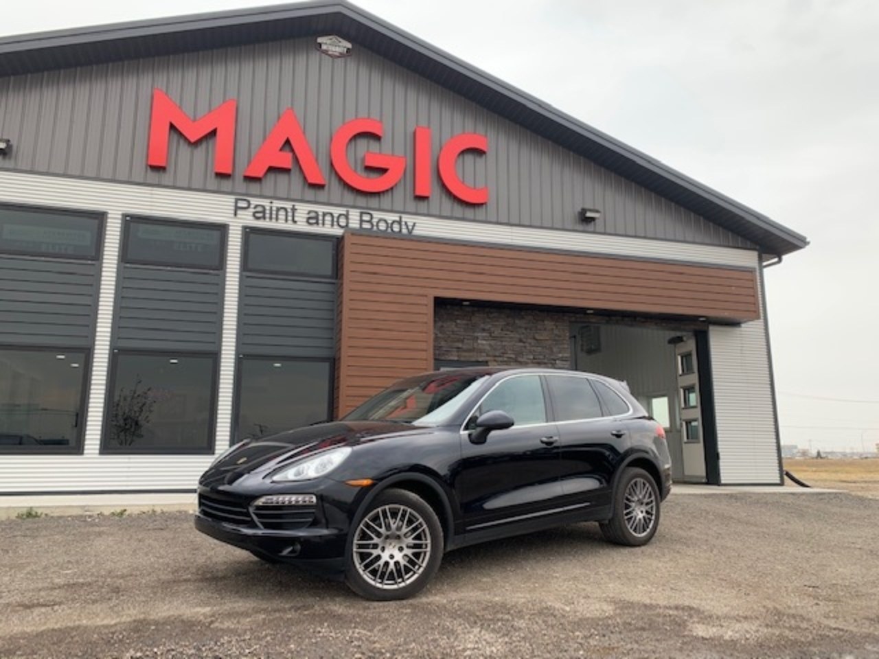 Vehicle in front of the Magic Paint & Body building