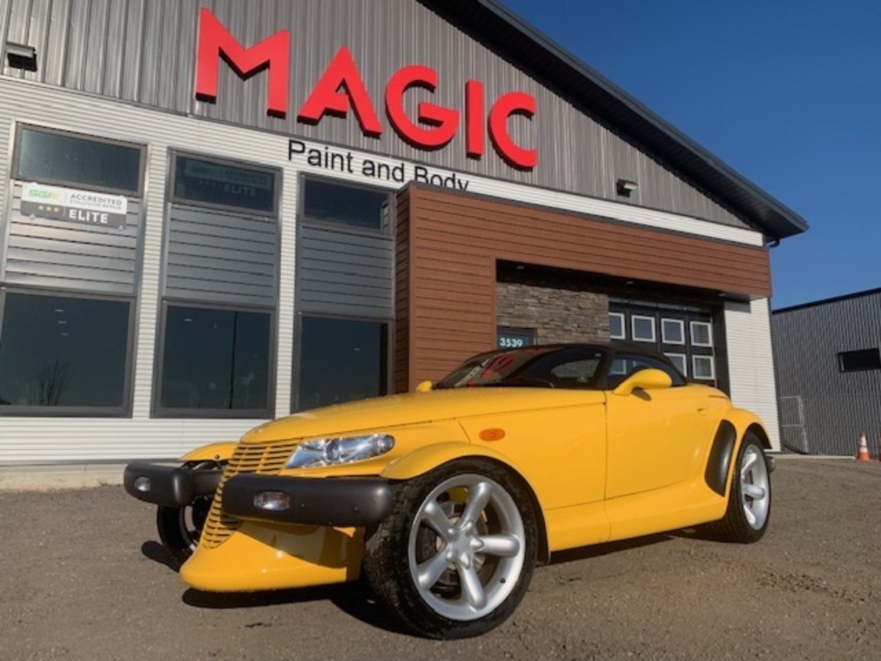 Yellow Plymouth Prowler outside the Magic Paint & Body shop